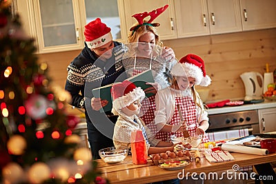 Family enjoying preparing Christmas cookies Stock Photo