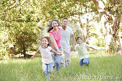 Family Enjoying Walk In Park Stock Photo