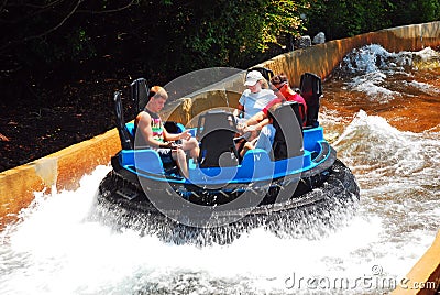 A family enjoys a water ride at an amusement park Editorial Stock Photo