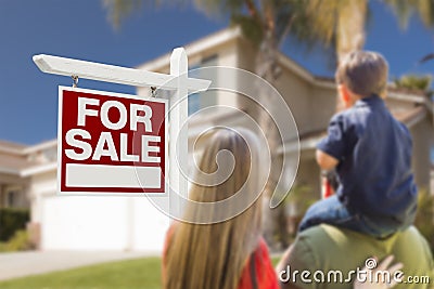 Family Facing For Sale Real Estate Sign and House Stock Photo