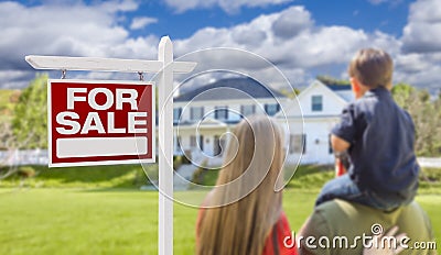 Family Facing For Sale Real Estate Sign and House Stock Photo