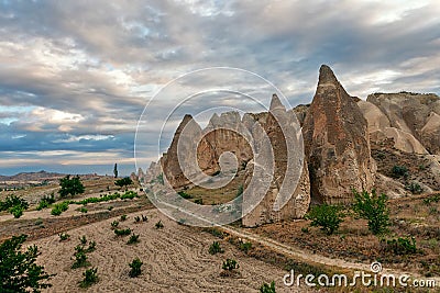 Family of fairy chimneys under cloudy sky Stock Photo