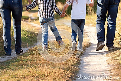 Family feet and legs in jeans. Stock Photo