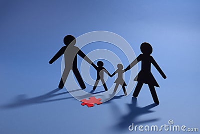 Family figure with red jigsaw piece Stock Photo