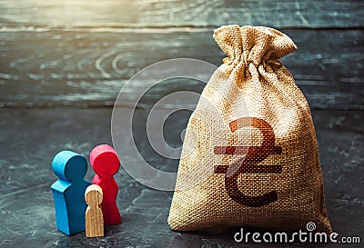 Family figurines and ukrainian hryvnia money bag. Social assistance and support. High debt. Social research, consumer preferences Stock Photo