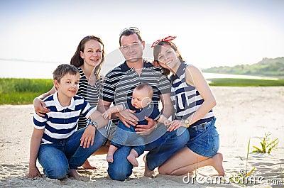 Family of five having fun on the beach Stock Photo