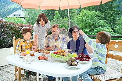The family from five persons have got dinner on summer terrace Stock Photo