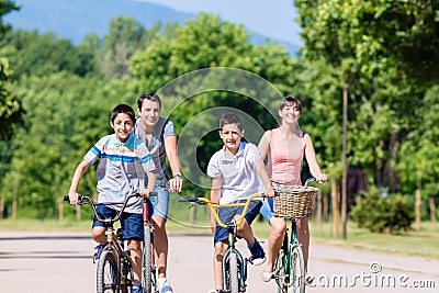 Family of four on bike tour in summer Stock Photo