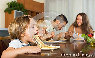 Family of four eating spaghetti Stock Photo