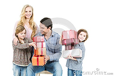 Family of four holding boxes with gifts. Stock Photo