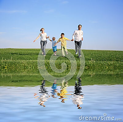 Family of four running Stock Photo