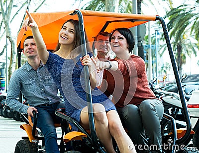 Family of four sitting in grand tour electric Stock Photo