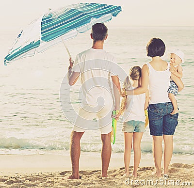 Family of four standing with back forward Stock Photo