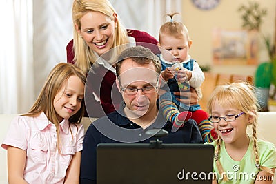 Family in front of computer having video conferenc Stock Photo