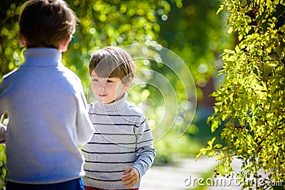 Family fun during harvest time on a farm. Kids playing in autumn garden Stock Photo