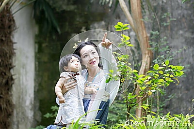 Family fun time, Chinese woman and baby in Hanfu dress enjoy free time Stock Photo