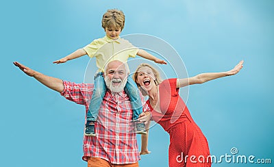 Family generation and relations concept. Concept of friendly family. Grandfather and little grandson with mother playing Stock Photo