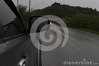 Beside of family gray car stop on asphalt road with rain. Stock Photo
