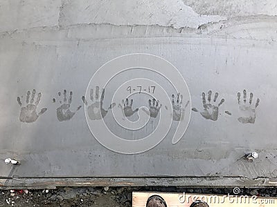 Family handprints in fresh concrete Stock Photo