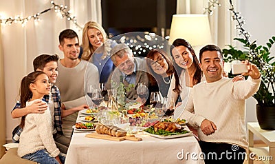 Family having dinner party and taking selfie Stock Photo