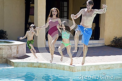 Family Having Fun Jumping Into Swimming Pool Stock Photo