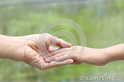 Family helping - Child hand put on mother hand with love and care Stock Photo