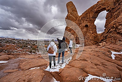 Family hiking in red mountains in Utah during winter. Stock Photo