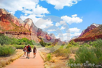Family on hiking trip in the mountains walking on pathway. Stock Photo