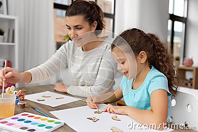 happy mother with little daughter drawing at home Stock Photo