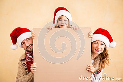 Family holding Christmas poster Stock Photo