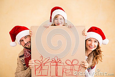 Family holding Christmas poster Stock Photo