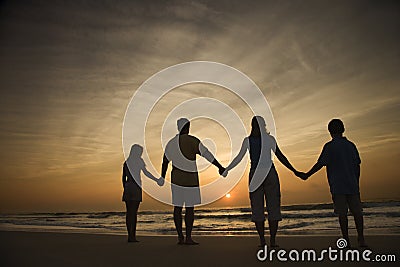 Family Holding Hands on Beach Stock Photo