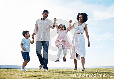 Family, holding hands and outdoor at a park with love, care and happiness together in nature. Young man and woman or Stock Photo