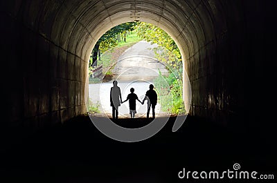 Family holding hands in the tunnel Stock Photo