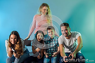 Family holding joysticks and start virtual game Stock Photo