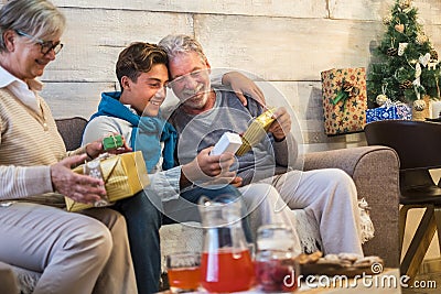 Family at home enjoying and celebrating christmas time night together with presents and gits for traditional exchange - happy Stock Photo