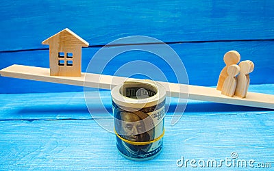 Family, house and dollars on the scales/ balance. buying selling renting a house and an apartment. credit mortgage property tax. i Stock Photo