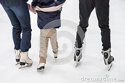 Family ice skating at rink. Winter activities Stock Photo