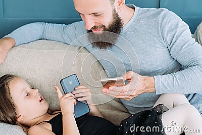 Family idle leisure communication girl dad phone Stock Photo