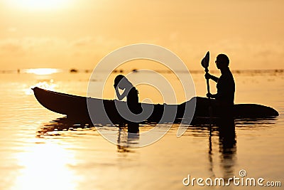 Family kayaking at sunset Stock Photo