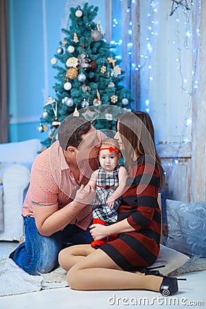 Family with Kid kissing. Happy Smiling Parents and Stock Photo