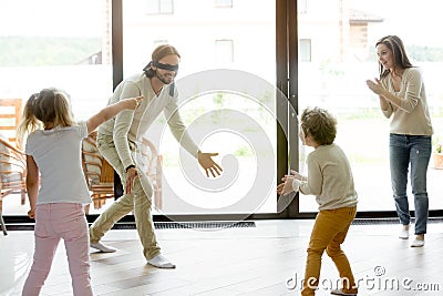 Family kids playing funny hide and seek game at home Stock Photo