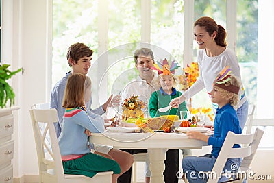 Family with kids at Thanksgiving dinner. Turkey Stock Photo