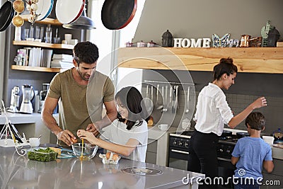 Family In Kitchen Making Morning Breakfast Together Stock Photo