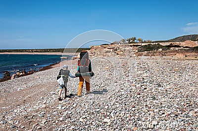 Family with large backpacks are on road sea Editorial Stock Photo