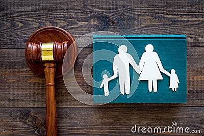 Family law, family right concept. Child-custody concept. Family with children cutout near court gavel on dark wooden Stock Photo