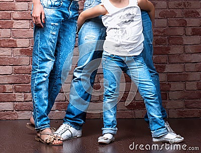 Family legs wearing blue jeans Stock Photo