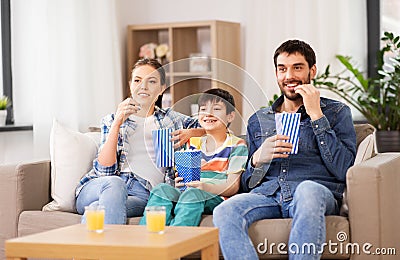 Happy family with popcorn watching tv at home Stock Photo