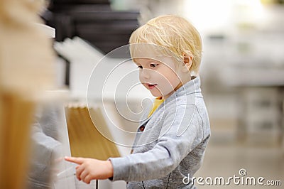 Family with little boy choosing the right furniture for their apartment in a modern home furniture store Stock Photo