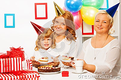 Family at little girl's birthday party Stock Photo